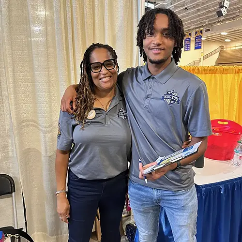 Two people smiling and posing together for a photo.