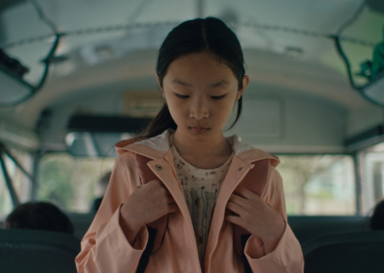 Asian American girl looking down and feeling uncomfortable