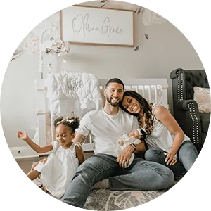 Dr. Brittney J. Fusilier pictured with her family in her newborn’s nursery.