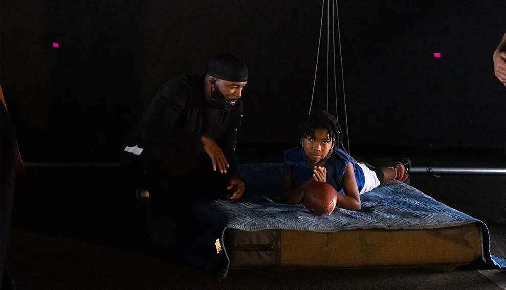 Andrew Hawkins preparing his son for his first stunt scene