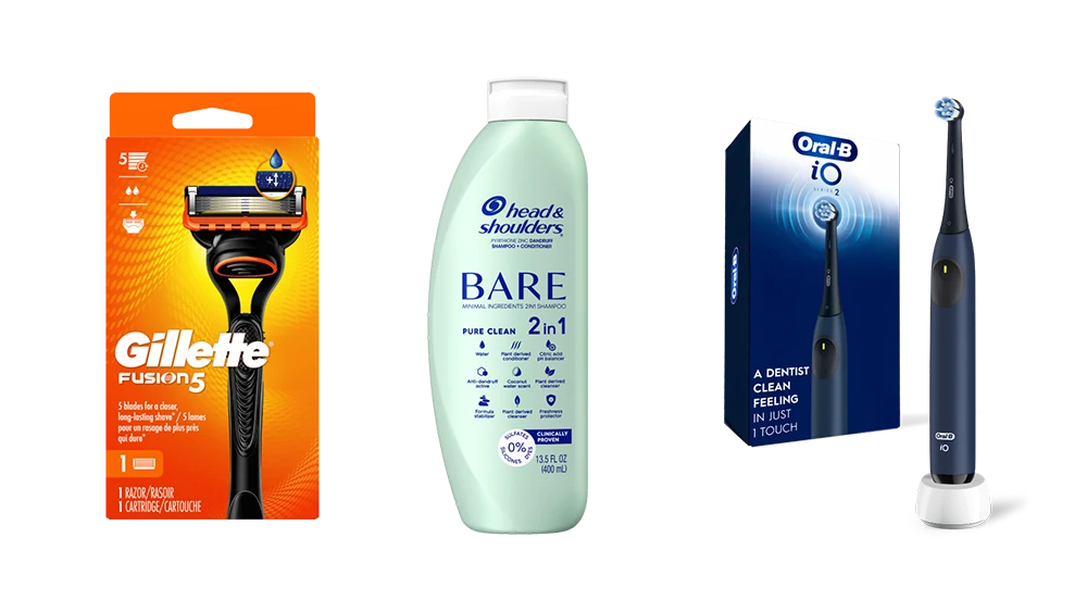 Three personal products lined up in a row. A box of a razor, a light green shampoo bottle, and a box with an electric toothbrush next to it.