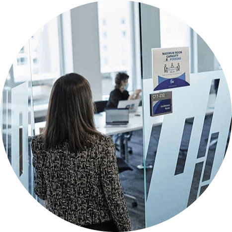 Image of woman entering conference room.