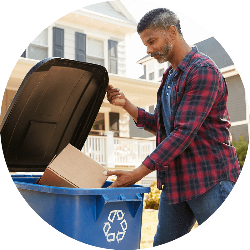 Man throwing packaging into a recycling bin