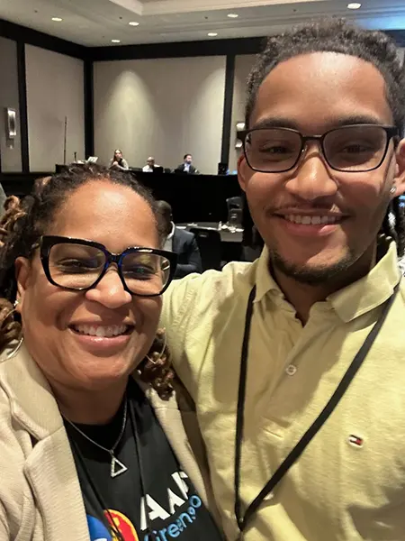 Two people smiling for a selfie.