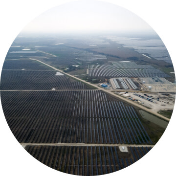 An aerial view of a large field with solar panels.