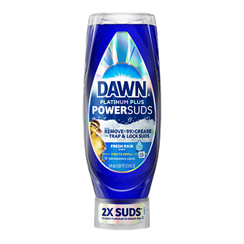 A blue bottle of dish soap with a label showing a duckling and claiming to remove 99% grease with 2X suds, against a black background.