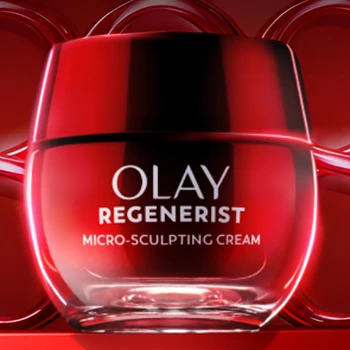 Red jar displayed against a red background with circular design elements. The words “Olay Regenerist Micro Sculpting Cream” are written on the front in silver