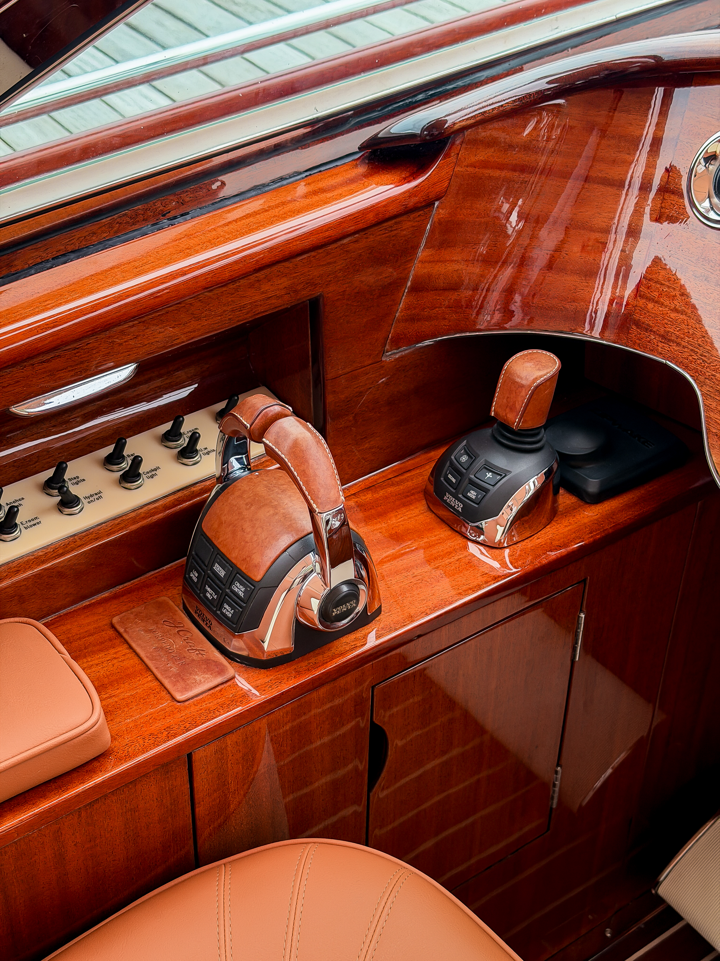 Chrome, marine leather, teak and mahogany at the cockpit controls.