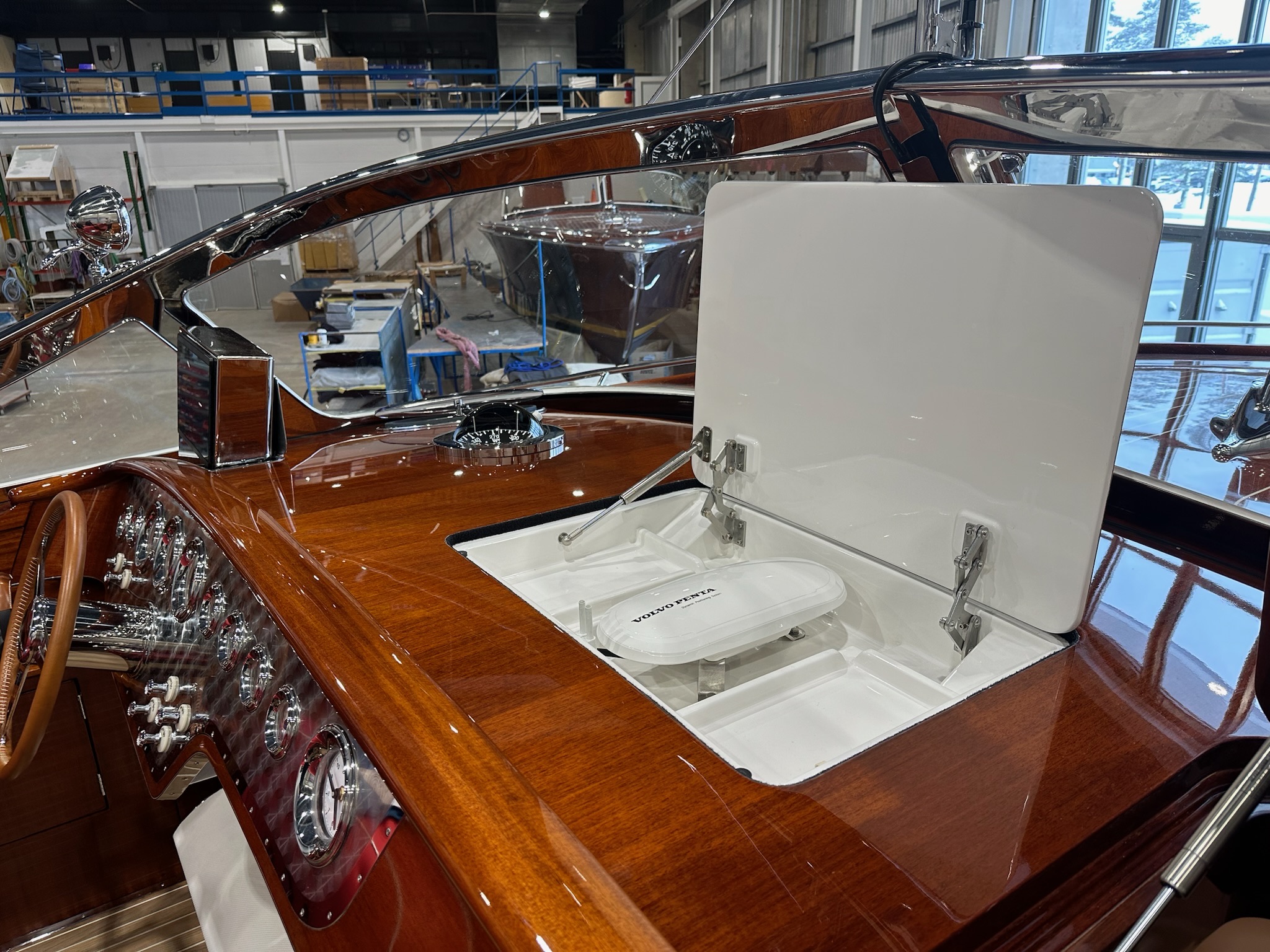 J Craft Torpedo mahogany dashboard with DPS hatch open, revealing the Garmin Skyhook dynamic positioning system beneath