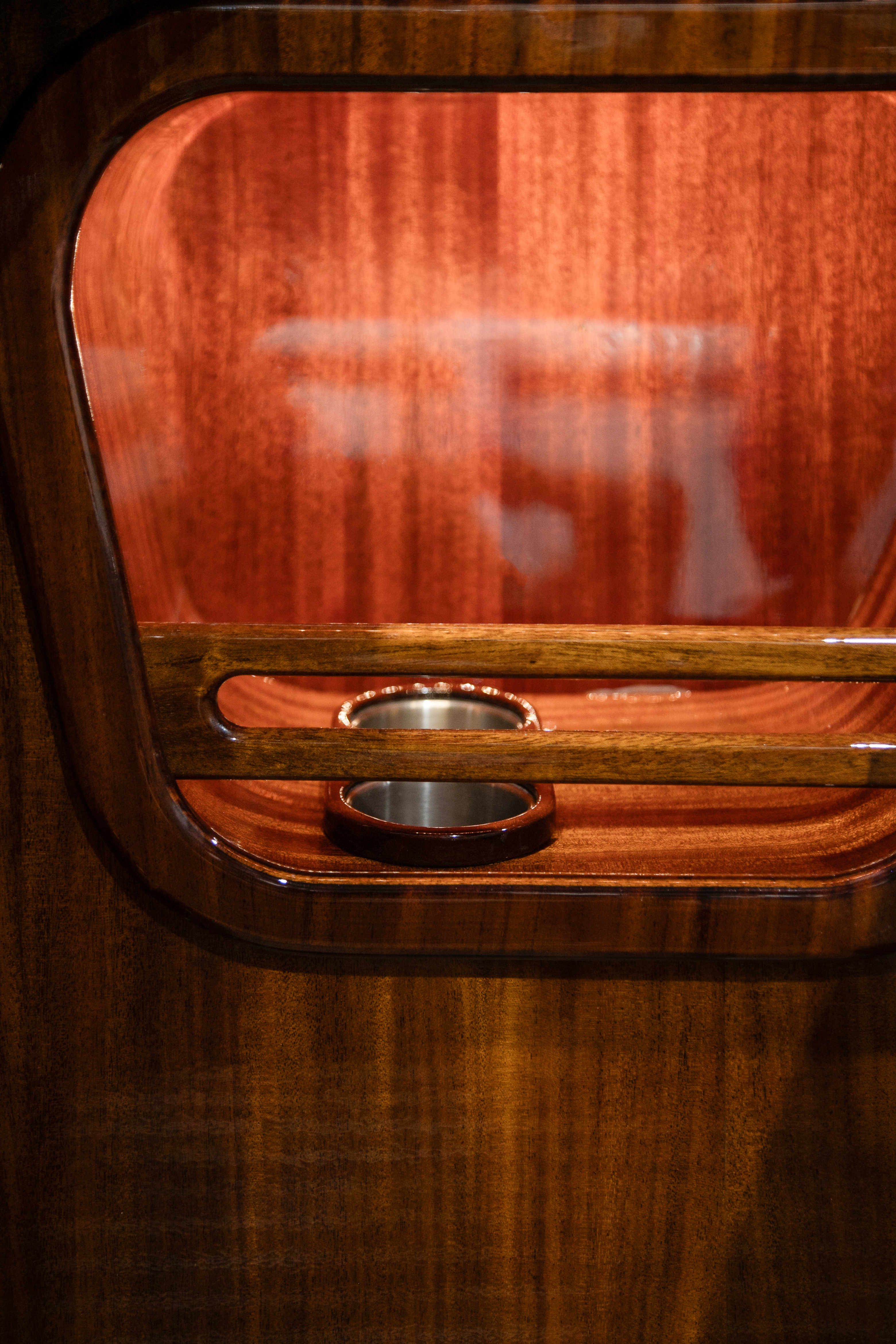 Stainless drinks holders recessed into the hand-worked mahogany.