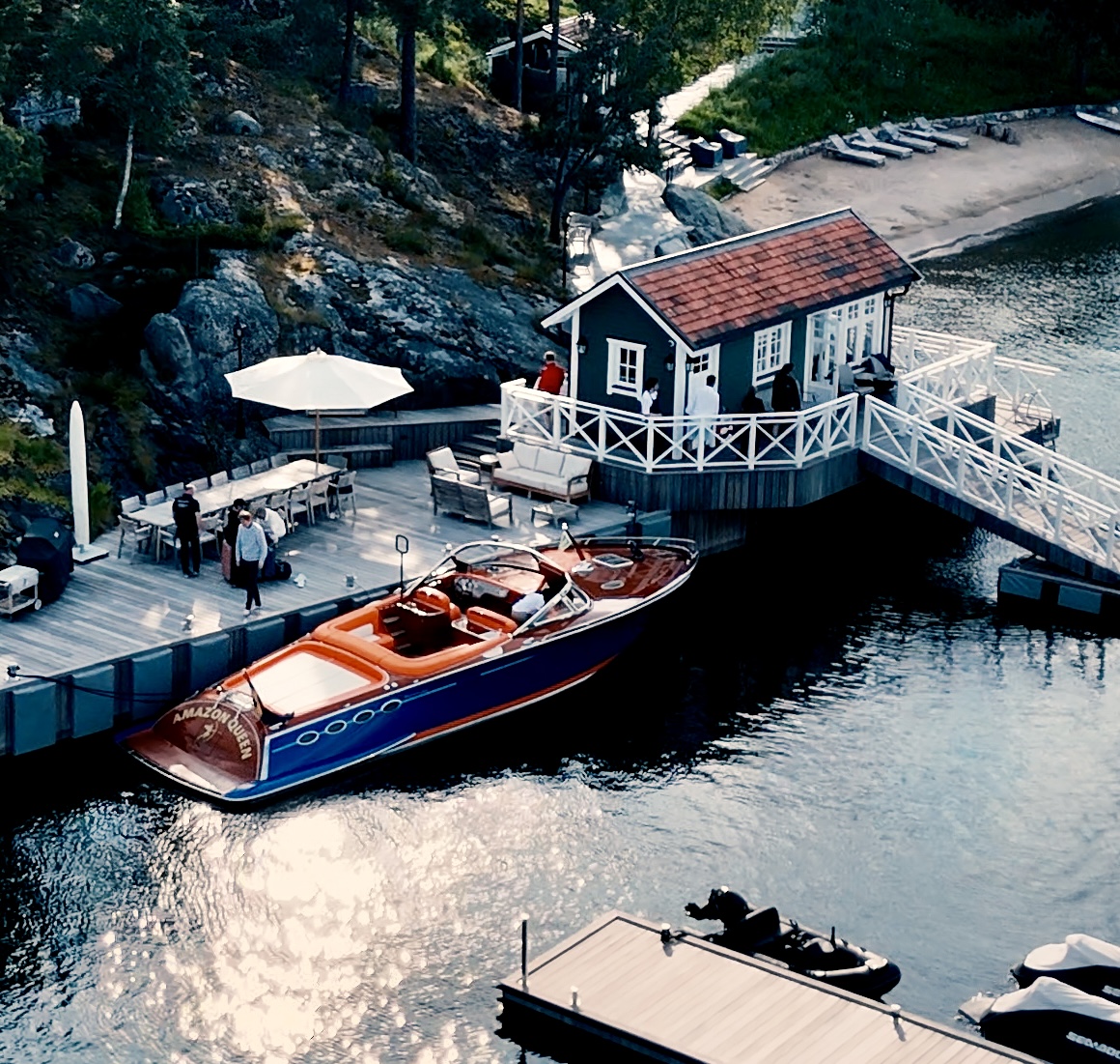 Amazon Queen alongside a rocky waterfront in Sweden.