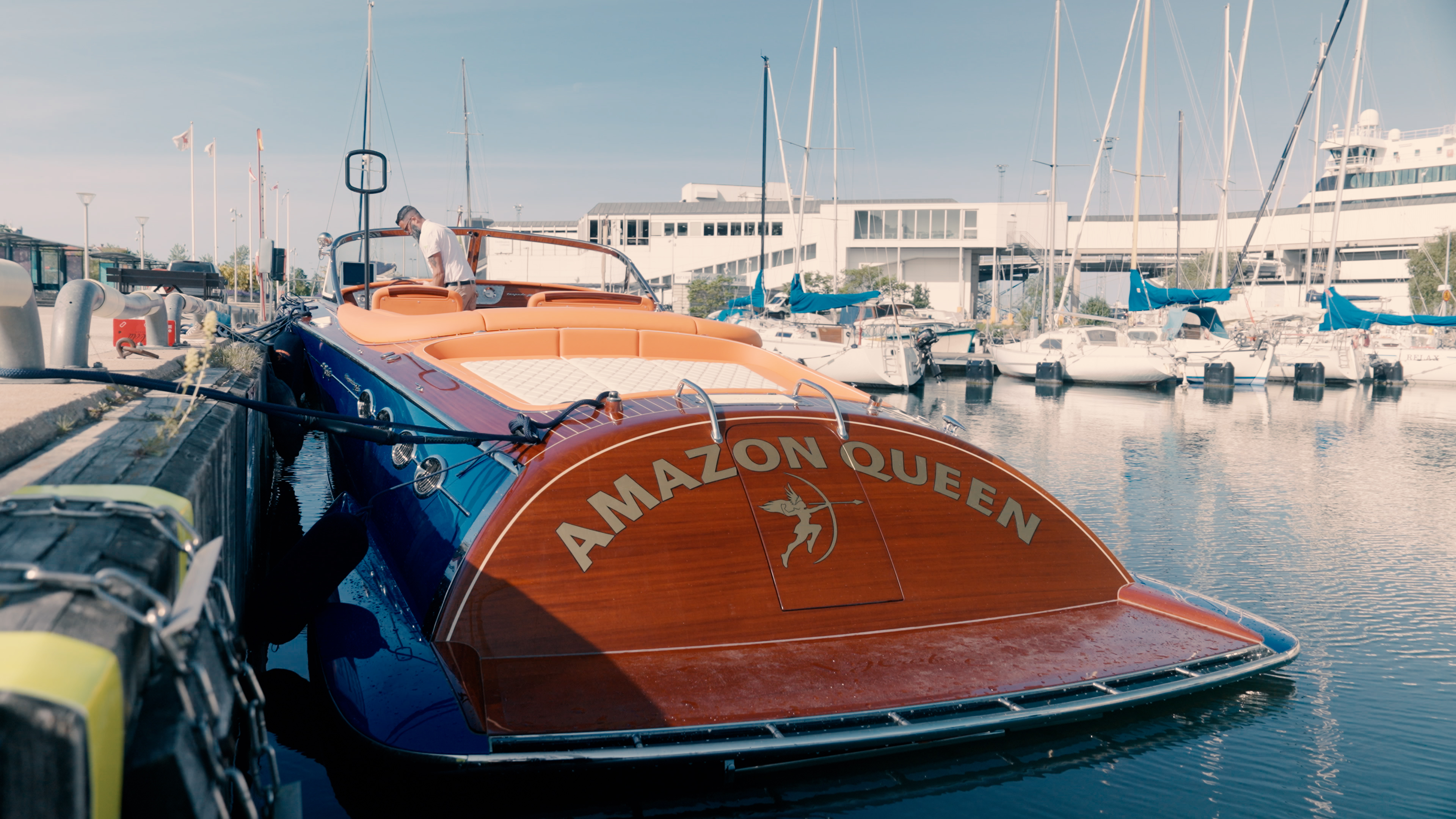 Amazon Queen's mahogany transom and woman-warrior emblem at the marina.