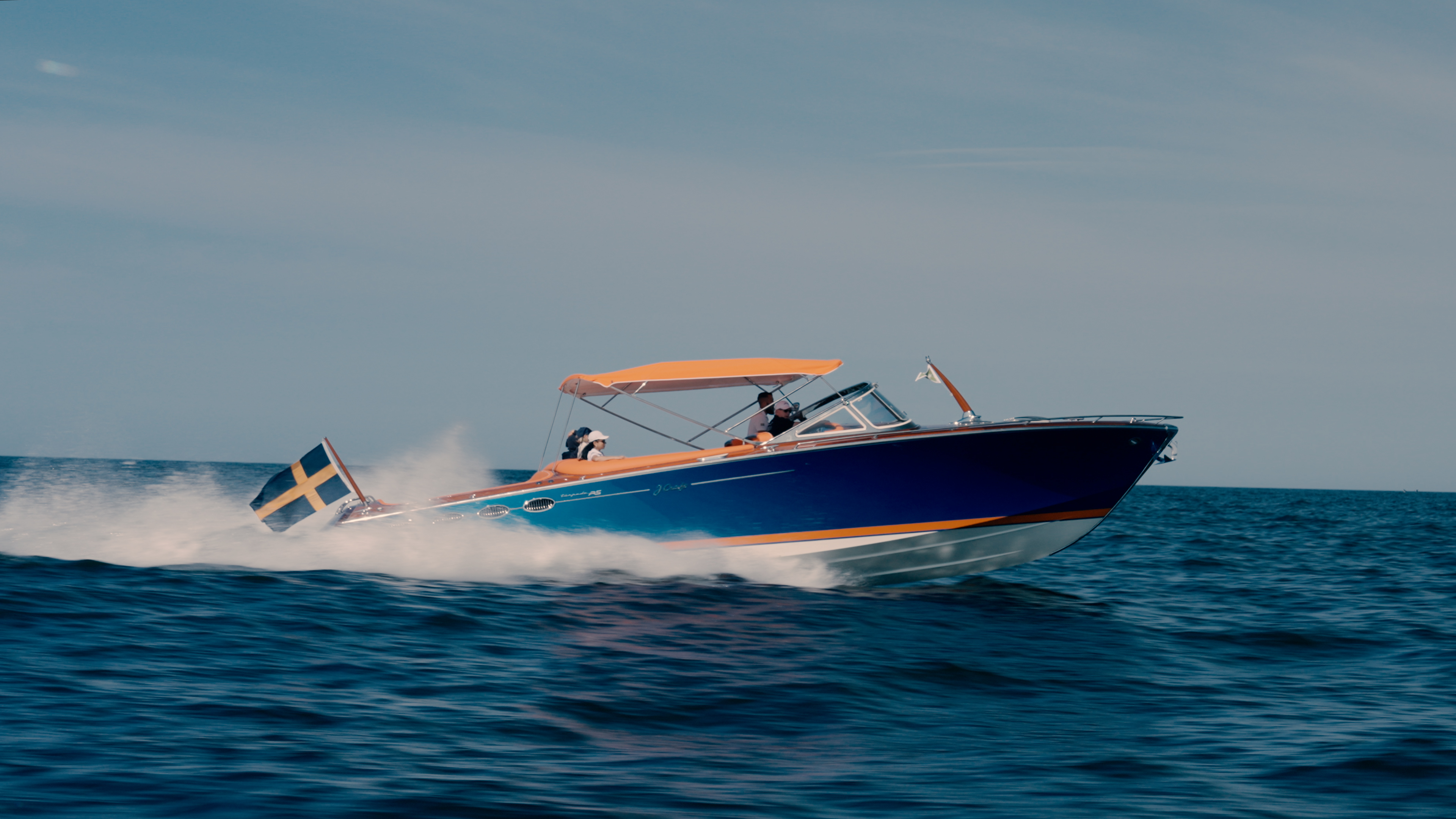Amazon Queen running at speed in open water under the Swedish flag.
