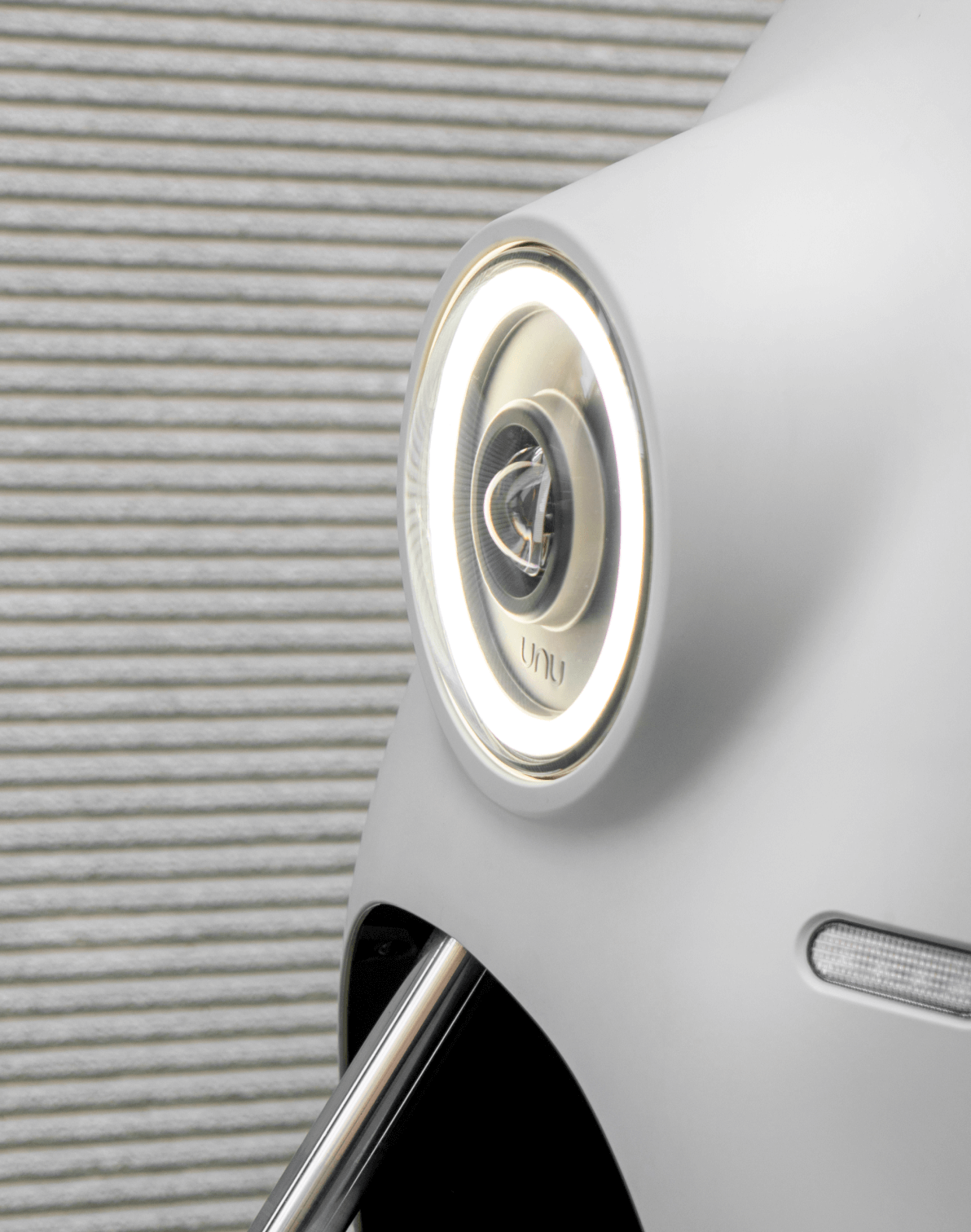 Front light close-up of white scooter