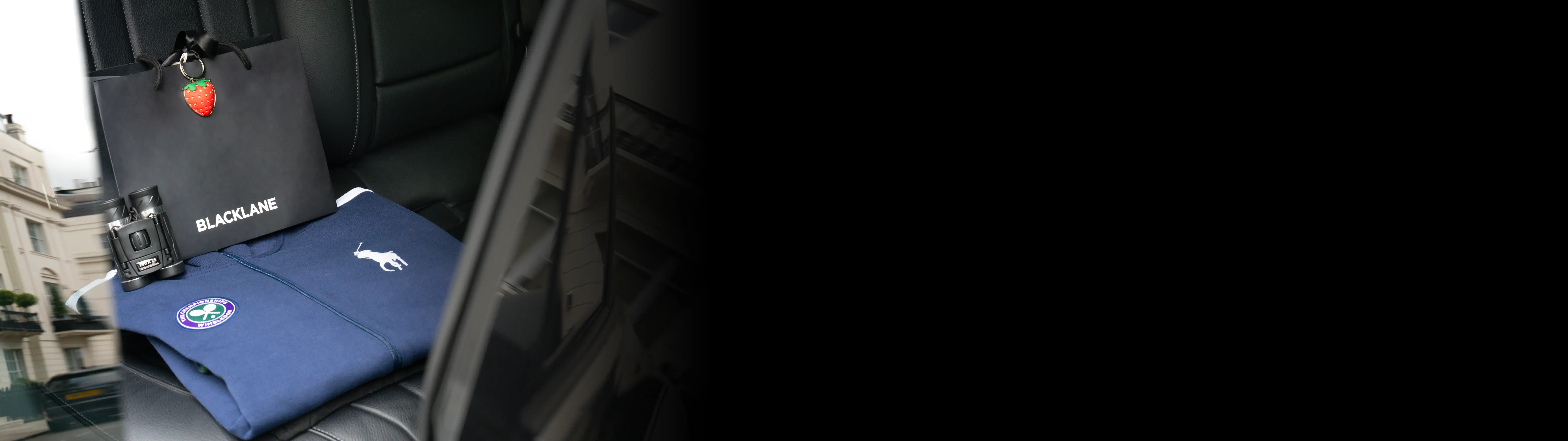 A shot of tennis swag in the backseat of a Blacklane Mercedes limousine.