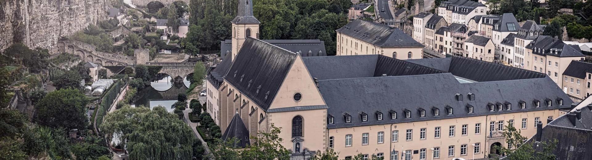 The historic town of Luxembourg, with winding streets and cobbled bridges.