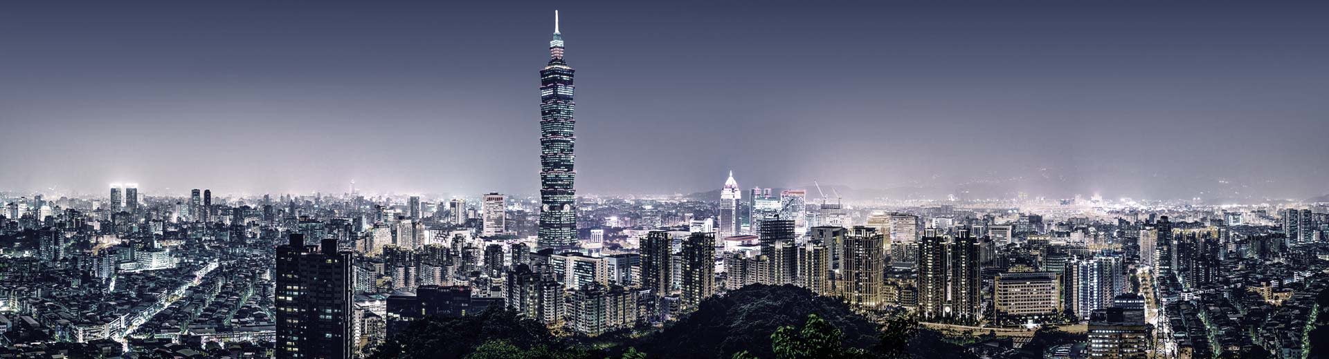The glittering cityscape of Taipei, with innumerable skyscrapers and high-rise apartment complexes as far as the eye can see.