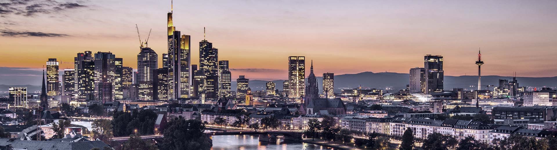 The looming skyscrapers of Frankfurt's financial district at sunset.