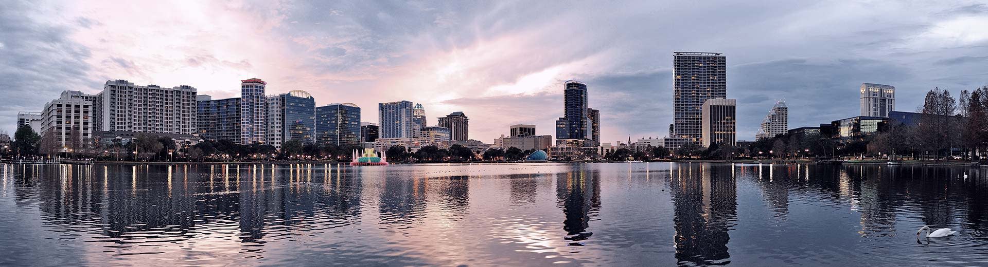 Tall square buildings of Orlando overlook the water of the Atlantic Ocean.