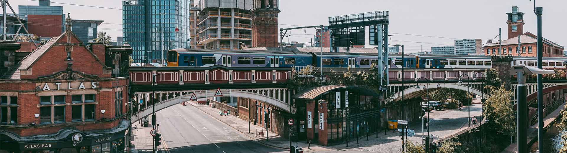 Commercial buildings and a modern bridge in Manchester