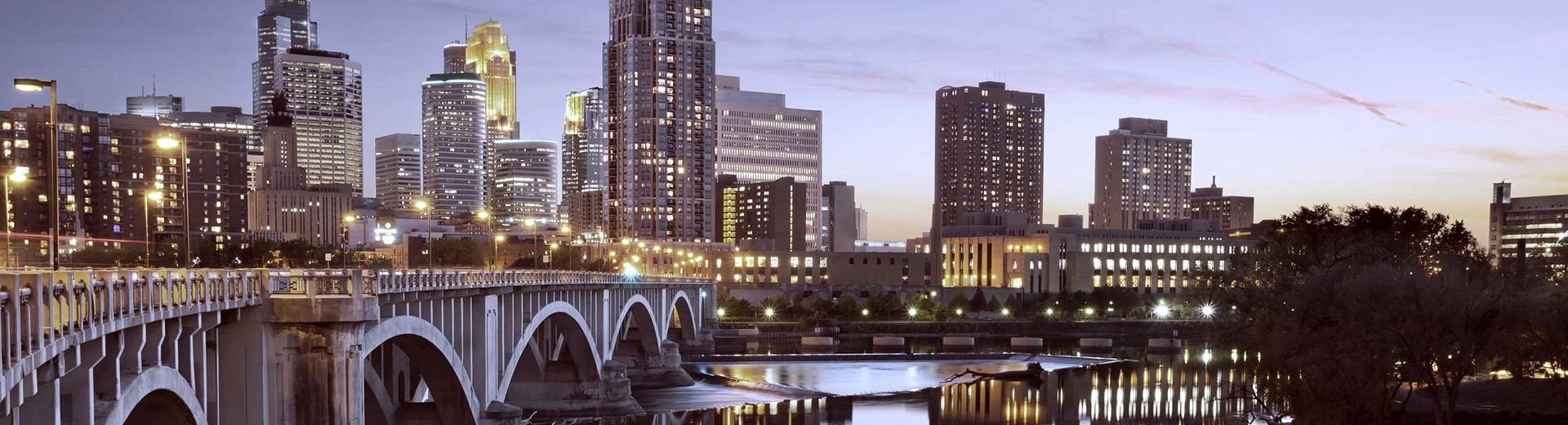 A bridge and high-rise skyscrapers light up the sky above Minneapolis.