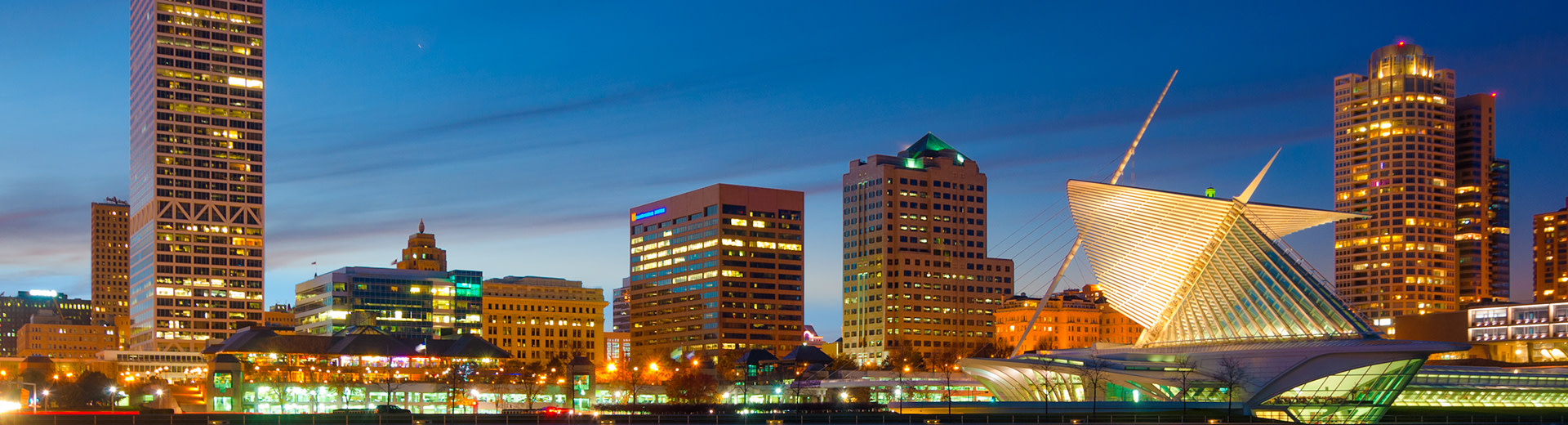 The skyline of Milwaukee, mainly office buildings, at night.