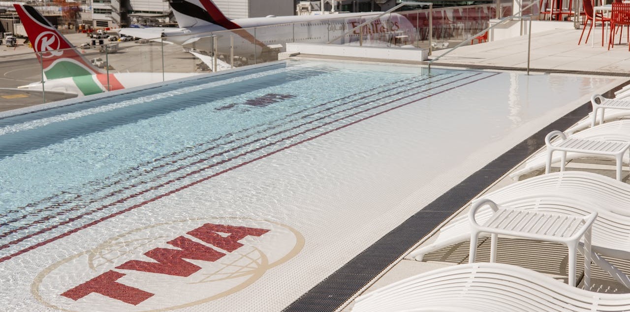 Shot the swimming pool on the roof of the TWA JFK airport lounge, showing the tails of planes on the tarmac in the background.