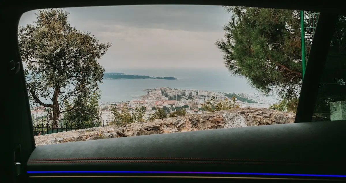Shot of a harbour on the Cote d'Azur through the window of a luxury car.