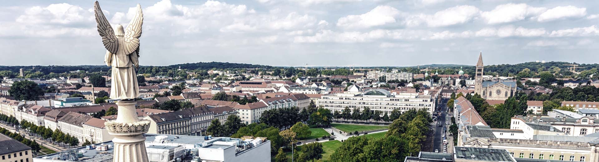 The beautiful east German town of Potsdam, with low-rise buildigns and plenty of green parks.