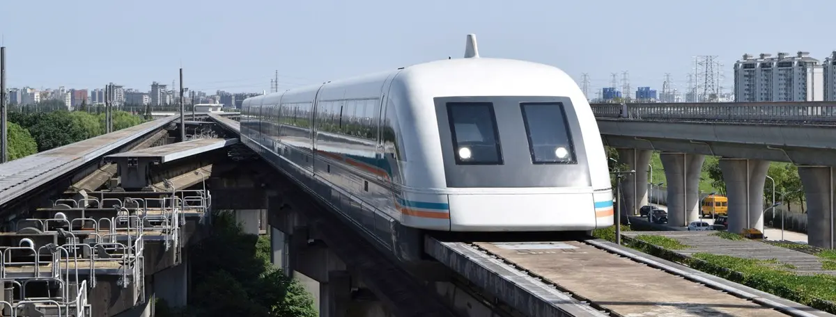 Shot of the Shanghai Maglev train coming towards the camera, with the city in the background.