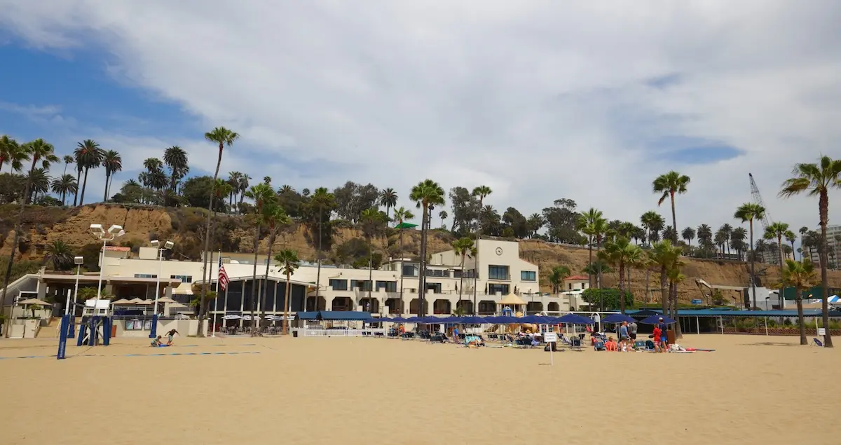 Shot of the Jonathan Beach Club in Santa Monica, shot from the beach, showing the building and palm trees around it.