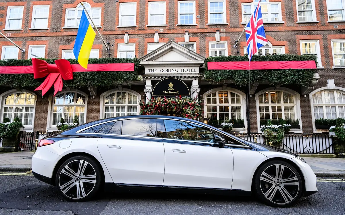 A two-tone Blacklane Mercedes limo sits outside The Goring Hotel in London.