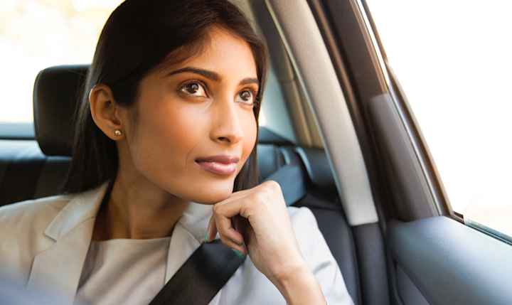 Person looks outside through their car window