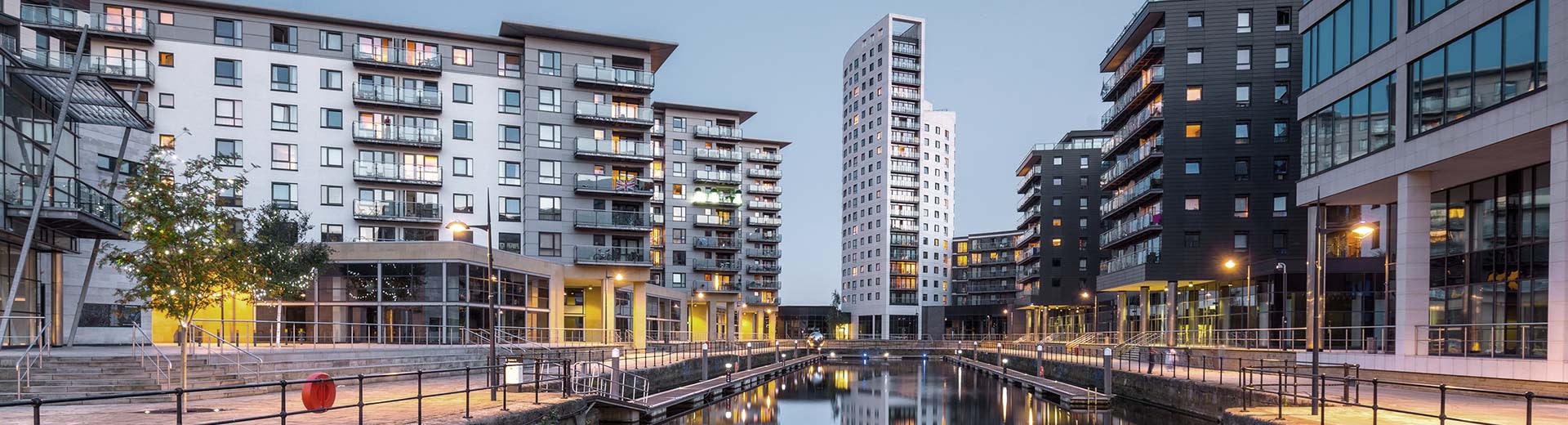 Modern residential buildings next to a canal in Leeds.