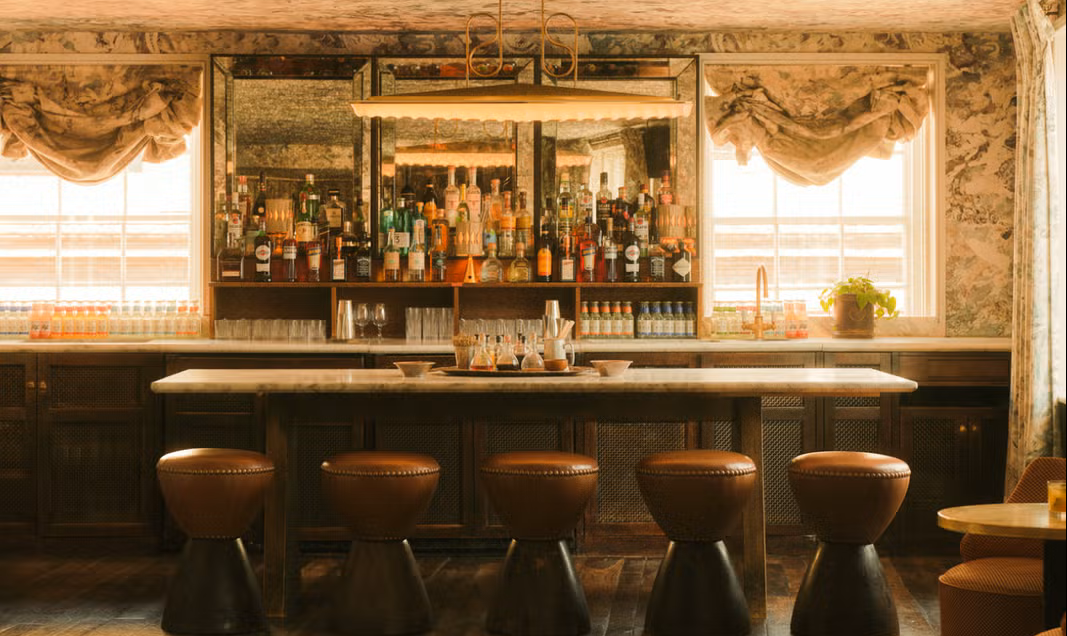 Shot of the sunlit bar in the Club Room at the London private members club Soho House Greek St.