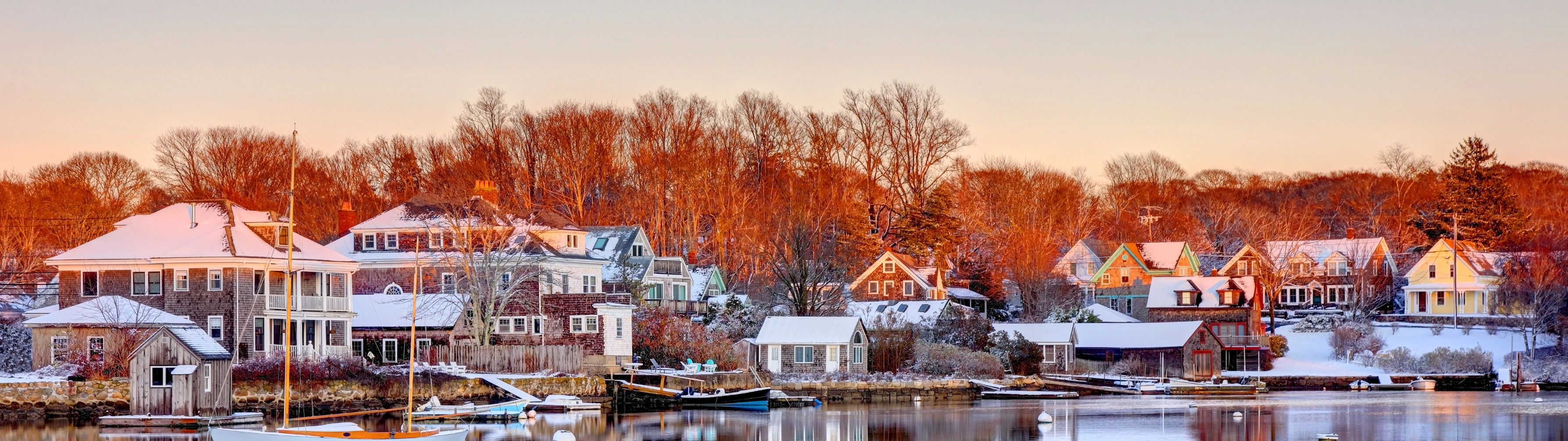 The beautiful town of Falmouth, MA, covered with snow. The trees are barren.