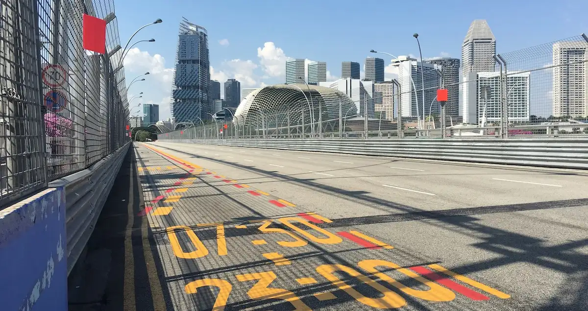 Shot of an empty section of the Singapore GP street circuit by day, with the Marina Bay skyscrapers in the background.