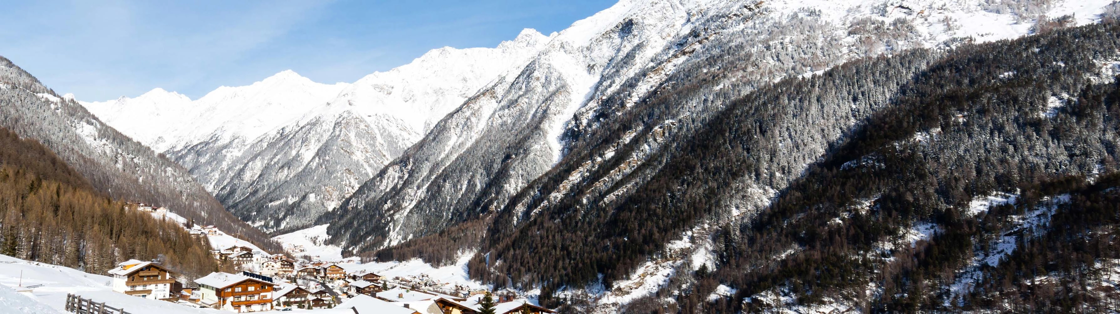 The imposing, tree-covered white mountains of Soelden.