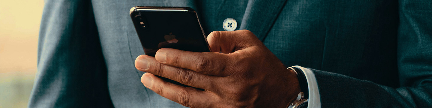 Man holding smartphone wearing suit