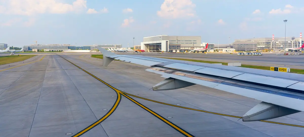 Shot from inside an airport at Shanghai Pudong Airport showing the terminal in the background.