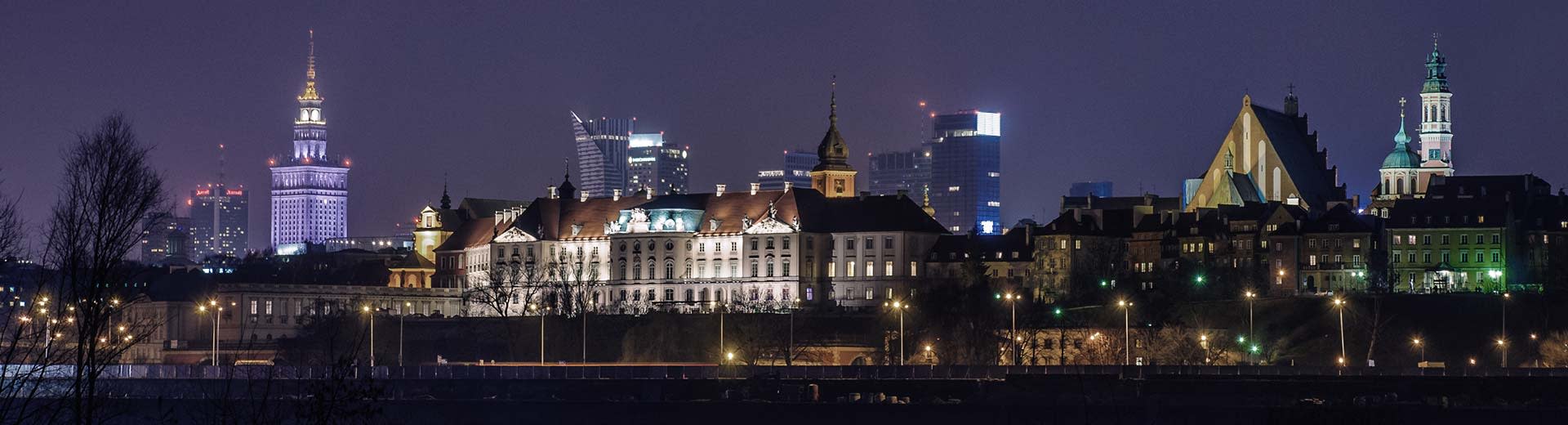 The famous Warsaw Palace of Culture and Science dominates the background, while in front are low-rise Polish apartments.