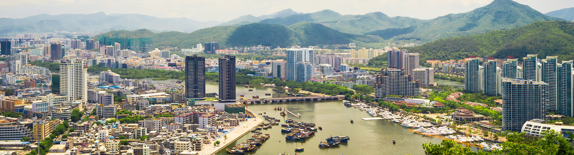 Skyscrapers and green parks dominate the aerial shot of Sanya.