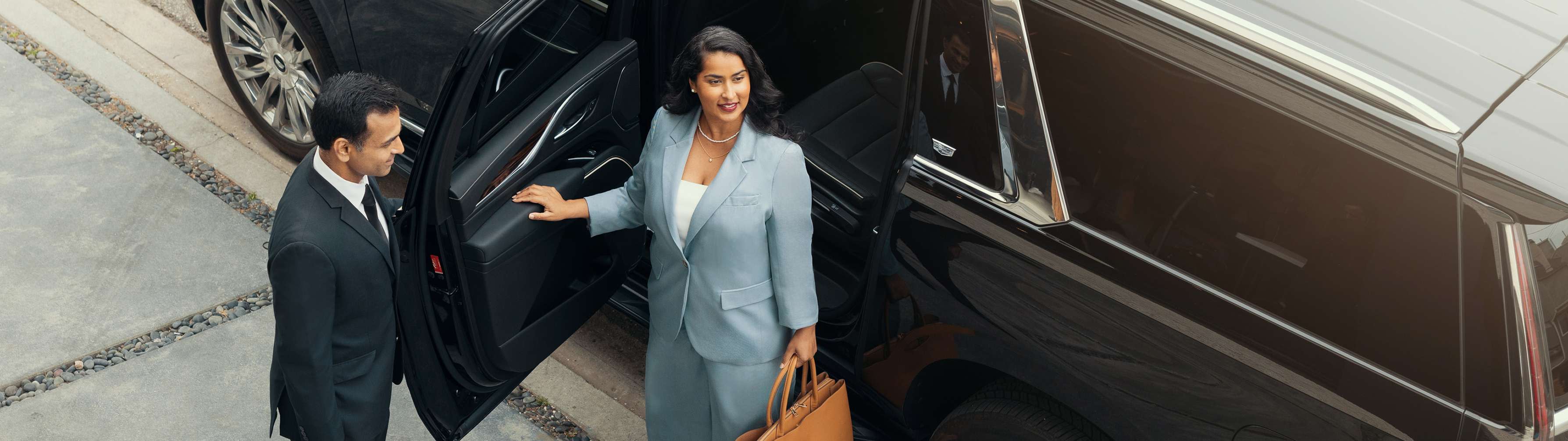 A businesswoman gets out of a Blacklane limo on her way to a meeting.