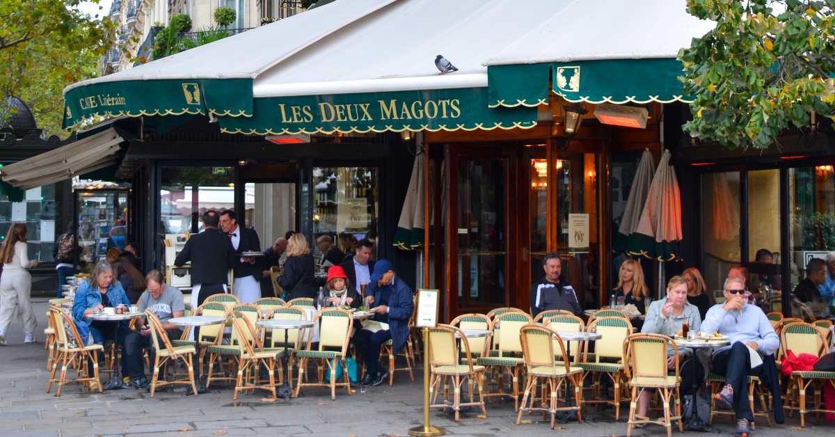 Les Deux Magots is a historic Paris café in Saint-Germain-des-Prés, famed as a gathering spot for writers, artists, and intellectuals since the 19th century.