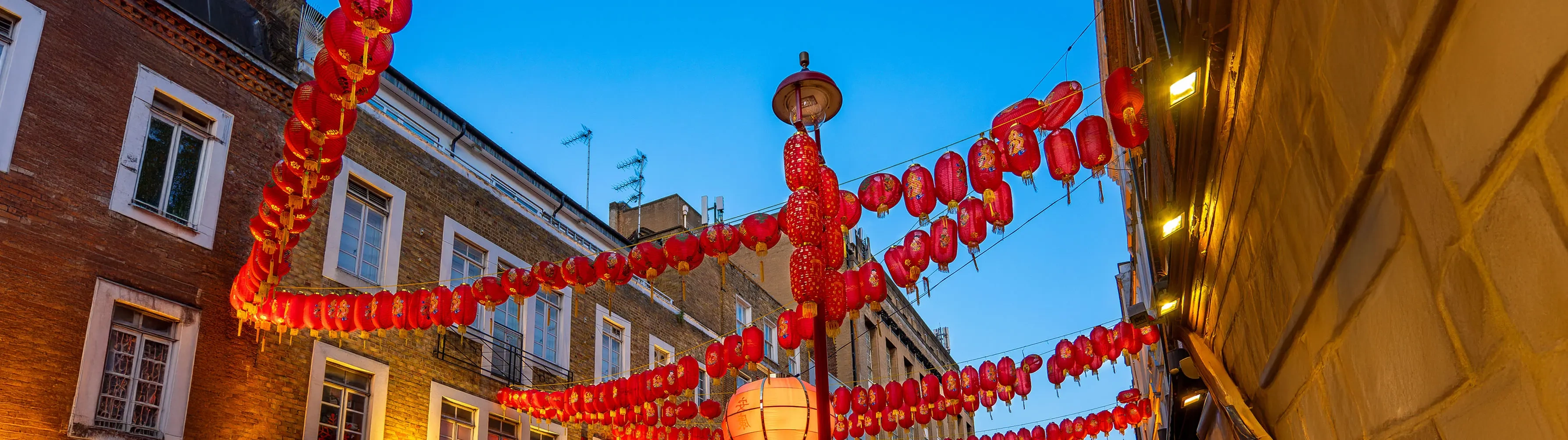 Chinese paper lanterns draped across the street in London's Chinatown district.