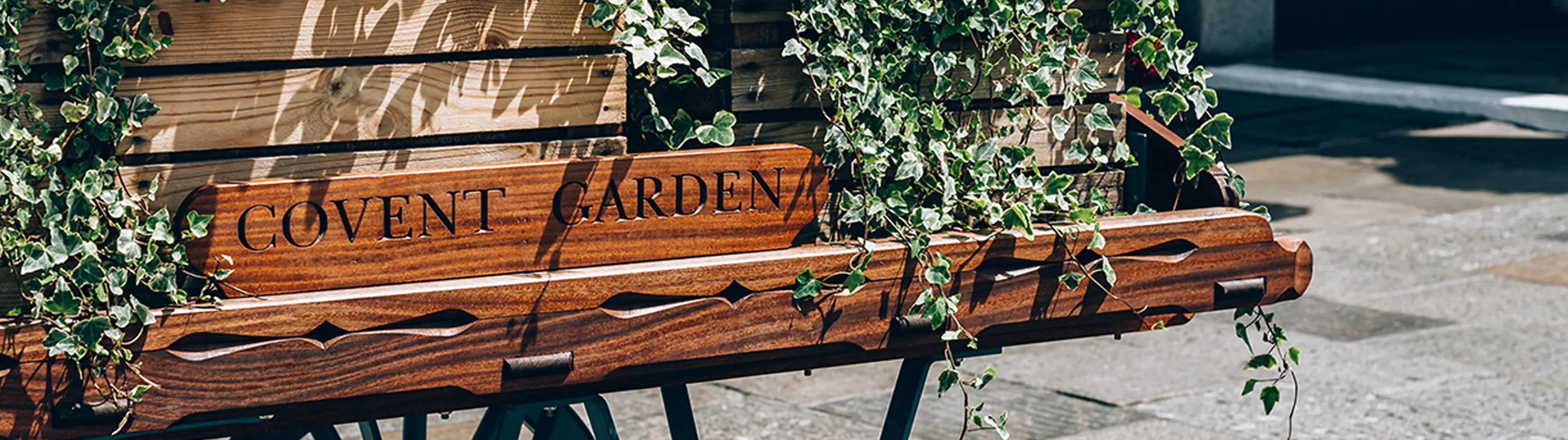 A wooden engraved sign in London's Covent Garden district.
