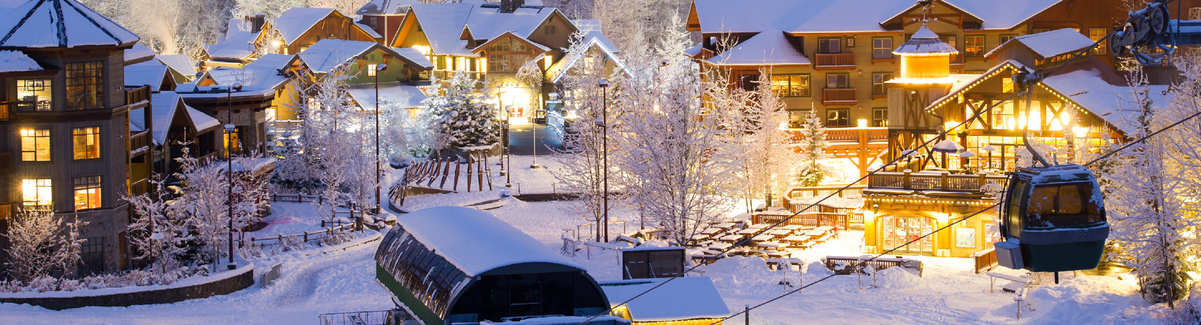 Snow-covered chalets look peaceful in the evening light.
