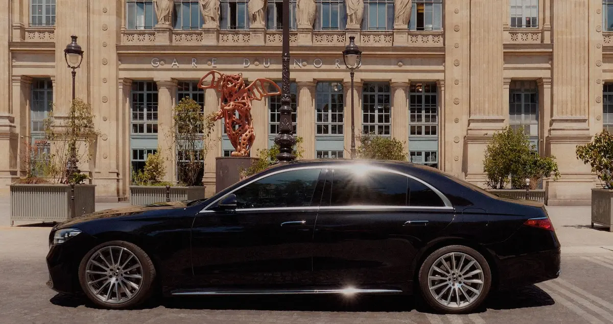 Side-on shot of a Blacklane Mercedes limousine outside the front of Paris's Gare du Nord.