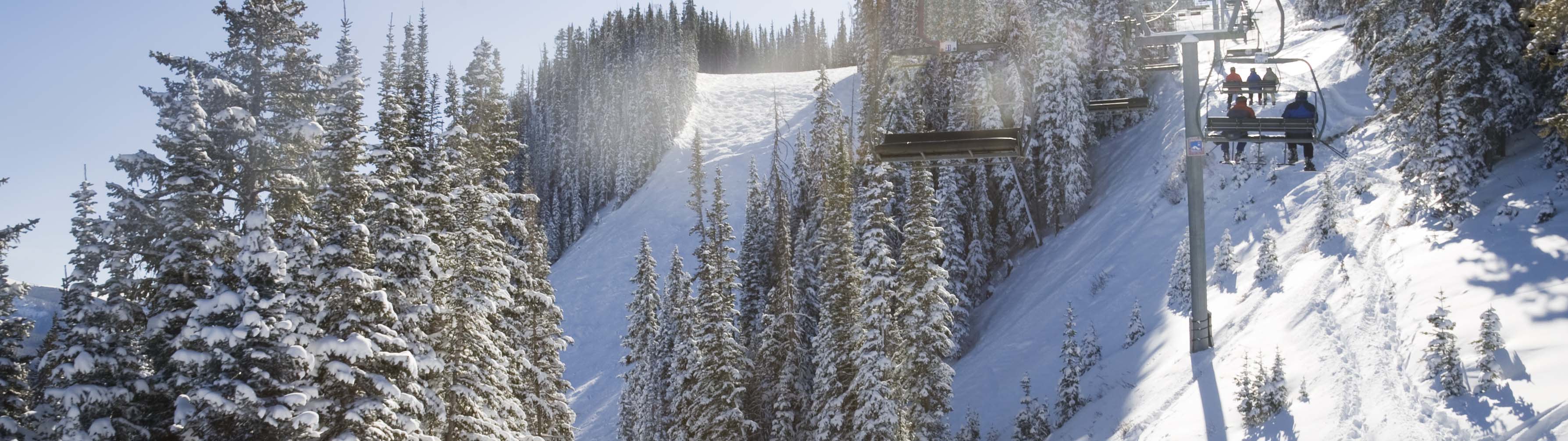 A ski lift takes guests up to the snowy summit in Aspen.