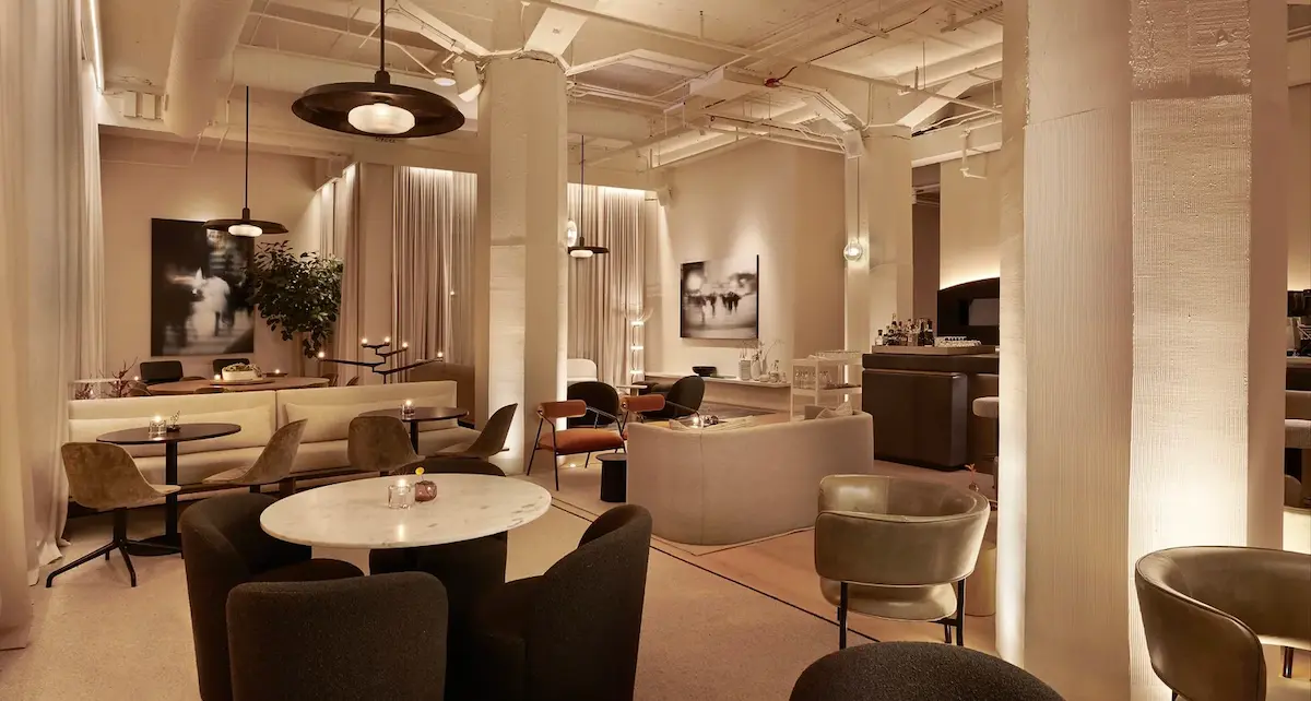 Shot of one of the lounges in Bian private members' club Chicago, showing pale tones, relaxed seating and soft lighting.